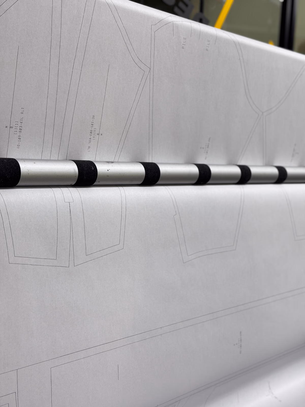 Industrial plotter printing ALLDENIMS garment patterns on paper