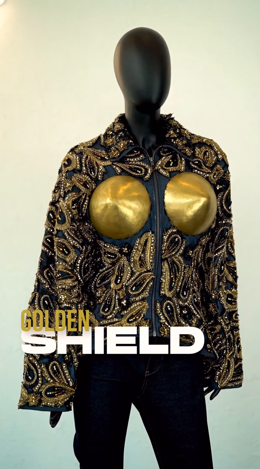 ALLDENIMS Golden Shield jacket — gold embroidery and metal chest pieces on a mannequin