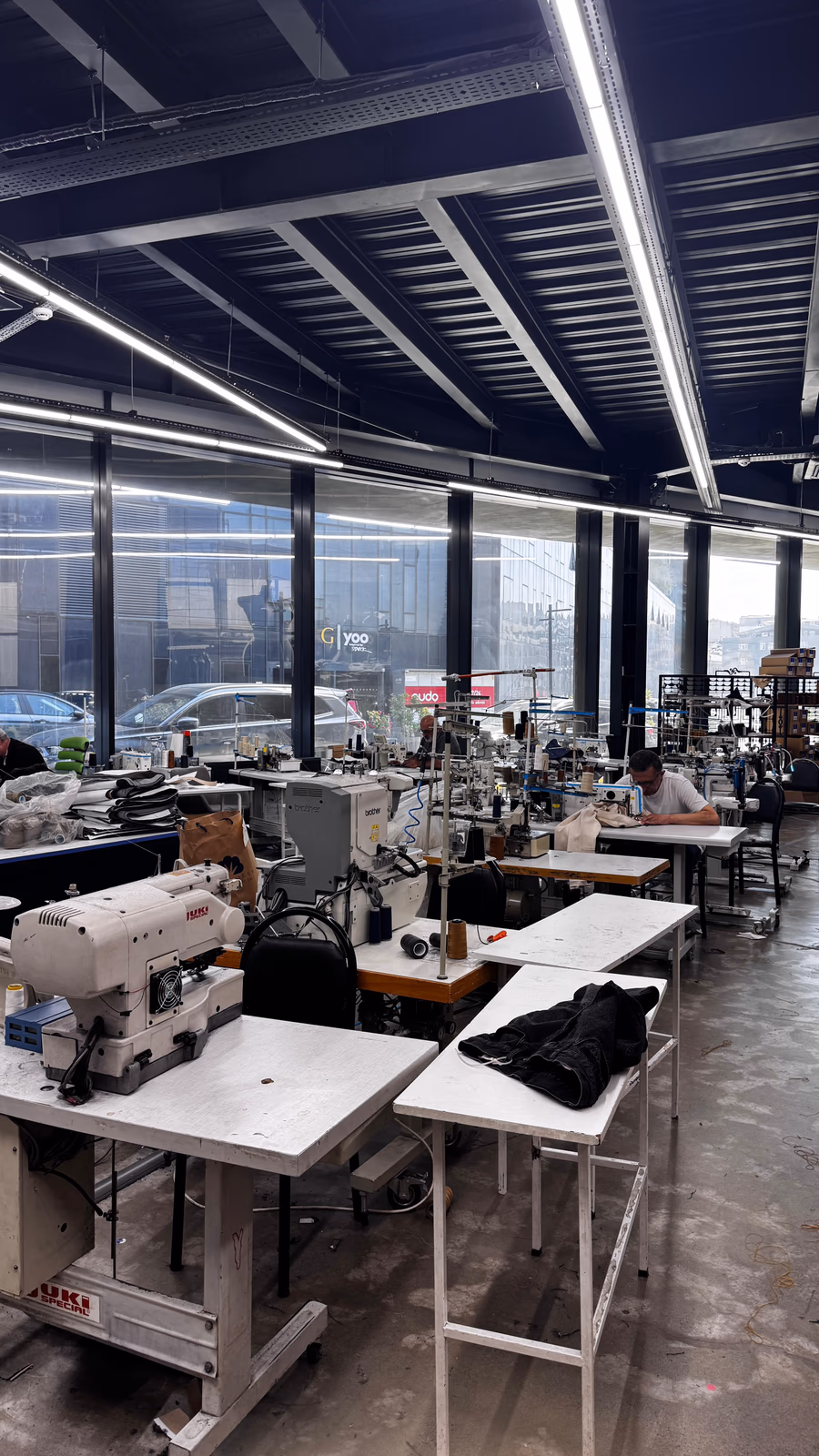 ALLDENIMS production floor with industrial sewing machines at work
