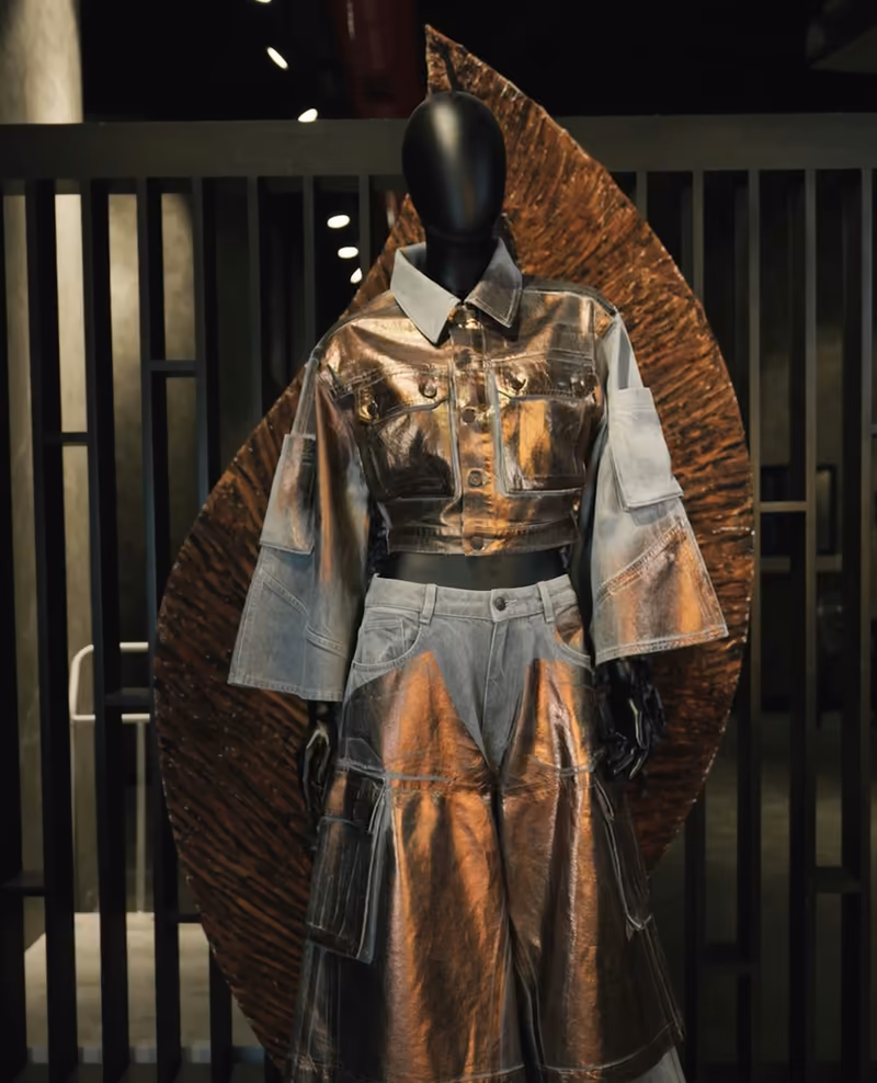 ALLDENIMS reconstructed denim look — light-wash denim and metallic bronze on a mannequin